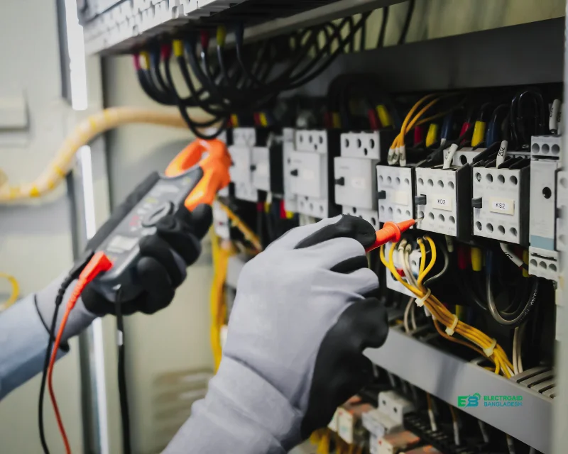 ElectroAID engineer working on an industrial electrical panel